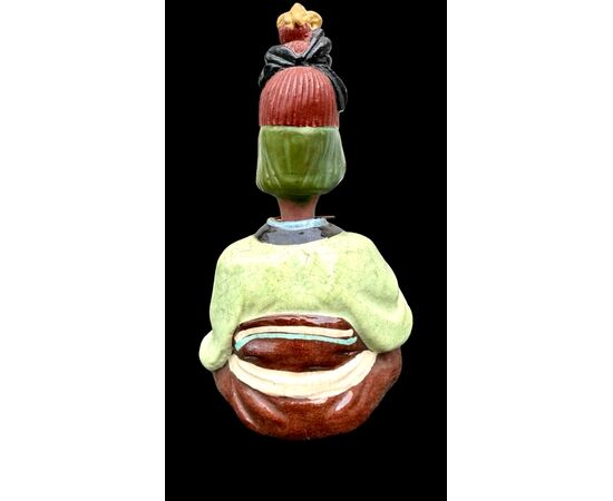 Ceramic figure depicting a Japanese character. Articulated head.