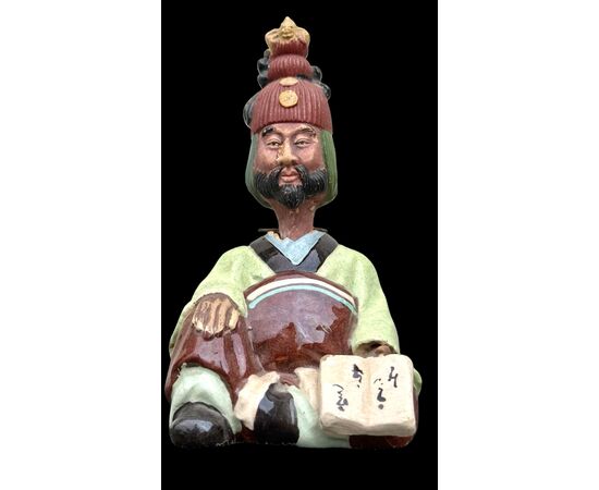 Ceramic figure depicting a Japanese character. Articulated head.