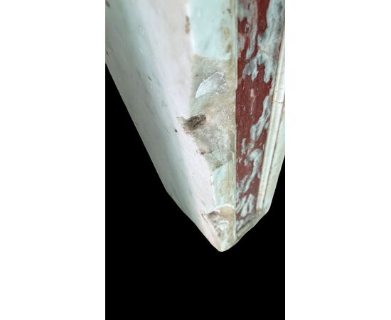 Three architectural elements in marble with a white frame and a variegated red central section.