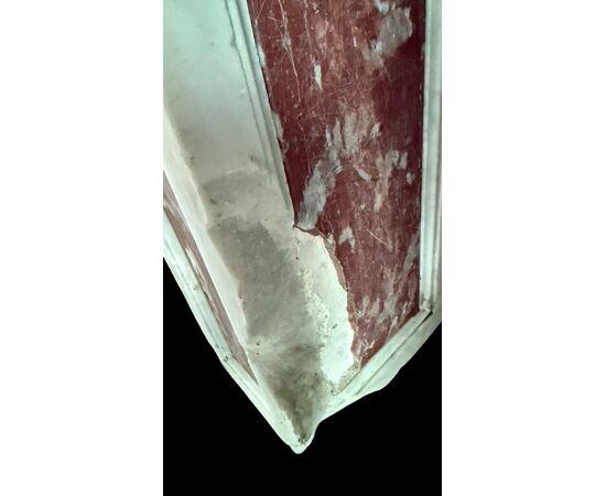 Three architectural elements in marble with a white frame and a variegated red central section.