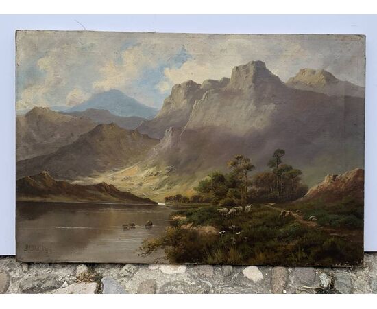 J. M. Ducker (British, early 20th century) - Mountain landscape with lake and sheep.