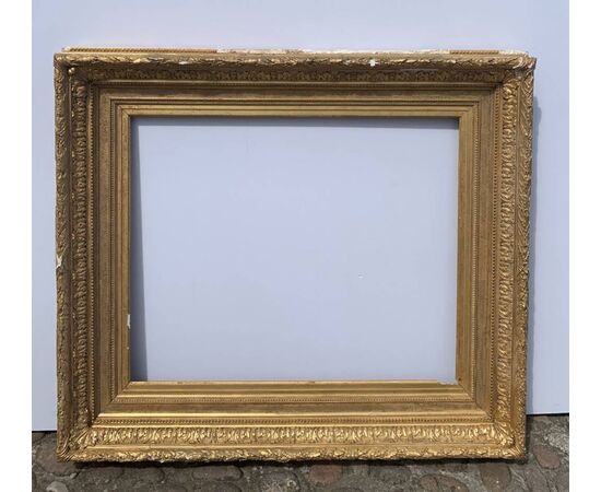Carved and gilded wooden frame with pastiglia reliefs. Italy, late 19th century.