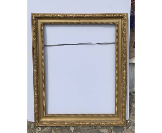 Empire style frame in carved and gilded wood. Italy, 19th century.