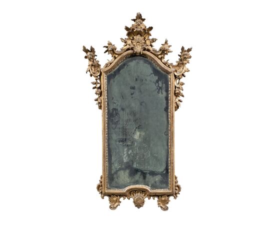 Carved and gilded wooden mirror. Northern Italy, 18th century.