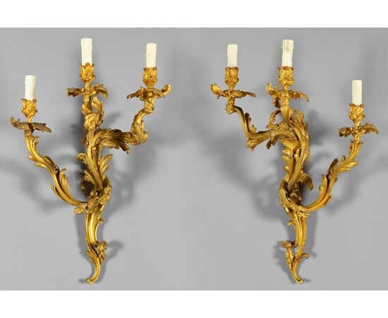 Pair of French gilded bronze three-light sconces, Louis XV style, 19th century