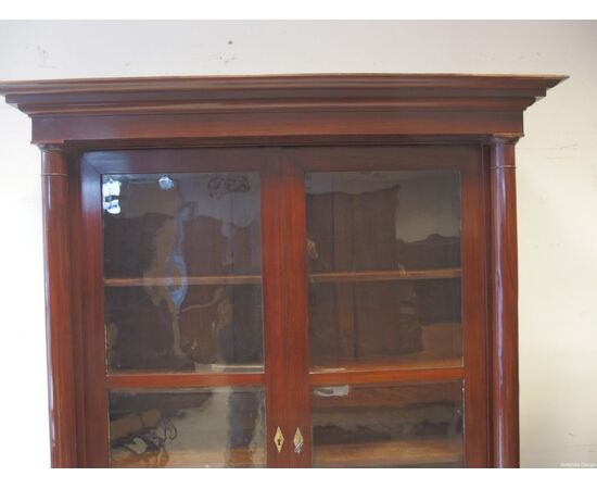 Mahogany bookcase with two doors and solid columns in Empire style from the early 1800s, dimensions: L148xW45xH228 cm.