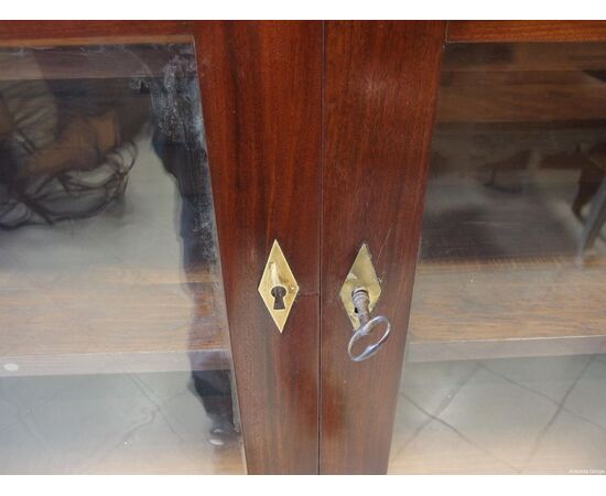 Mahogany bookcase with two doors and solid columns in Empire style from the early 1800s, dimensions: L148xW45xH228 cm.