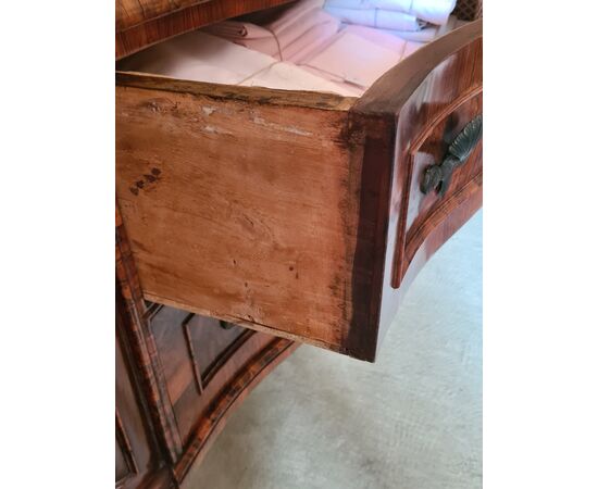 Bow-fronted chest of drawers.