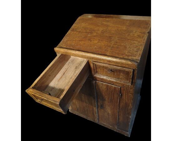 Small writing desk painted to look like wood.