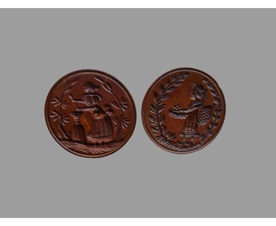 Two round butter stamps with handle, 19th century