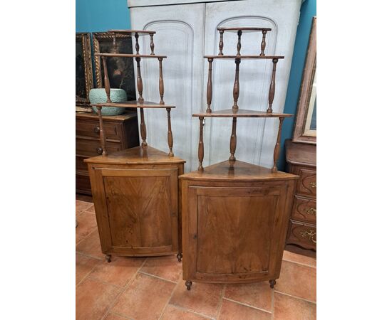 Pair of serpentine corner cabinets in blond walnut