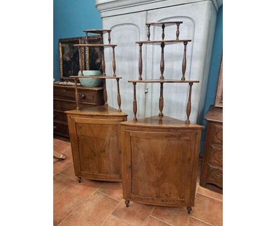 Pair of serpentine corner cabinets in blond walnut