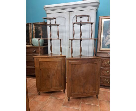 Pair of serpentine corner cabinets in blond walnut