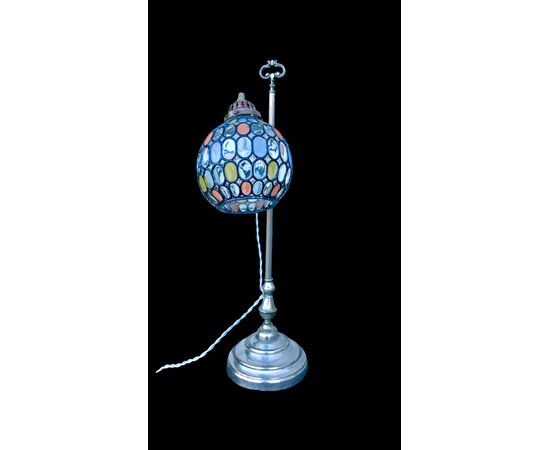Lamp with metal stem and globular part with leaded glass.