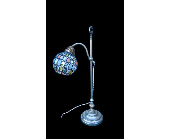 Lamp with metal stem and globular part with leaded glass.
