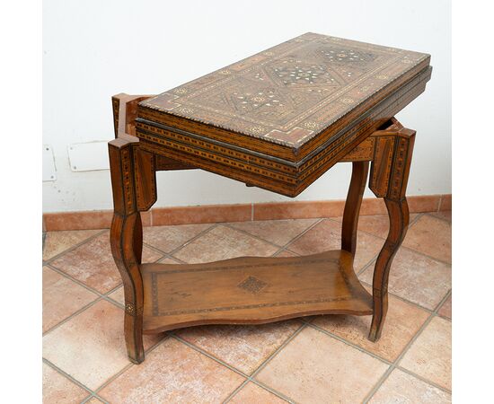 Antique game table in polychrome woods with mother-of-pearl inlays. Syria 19th century.