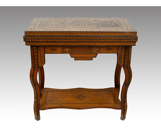 Antique game table in polychrome woods with mother-of-pearl inlays. Syria 19th century.