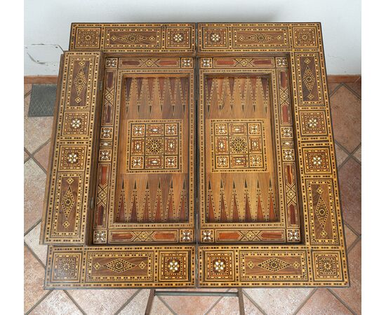 Antique game table in polychrome woods with mother-of-pearl inlays. Syria 19th century.