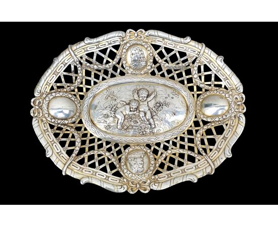 Pierced silver centerpiece with putti and figures. Holland.