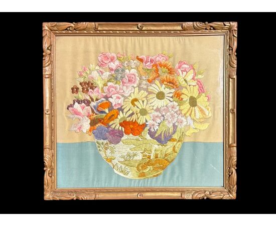 Framed panel with vase of flowers embroidered on fabric.