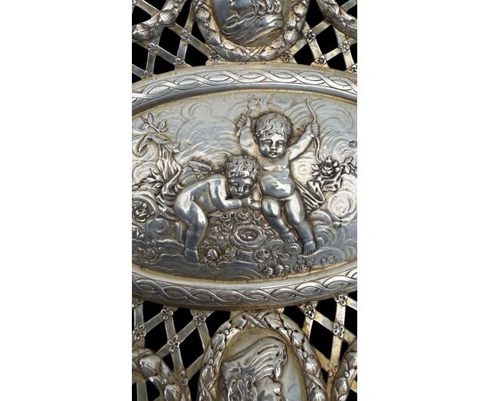 Pierced silver centerpiece with putti and figures. Holland.