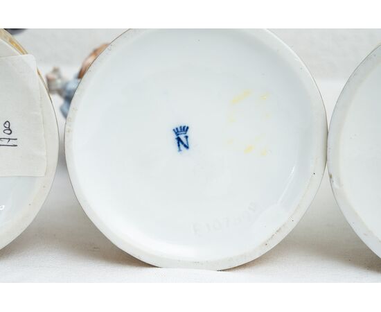 Group of four antique polychrome Capodimonte porcelain sculptures depicting the four seasons. Naples, 19th century.