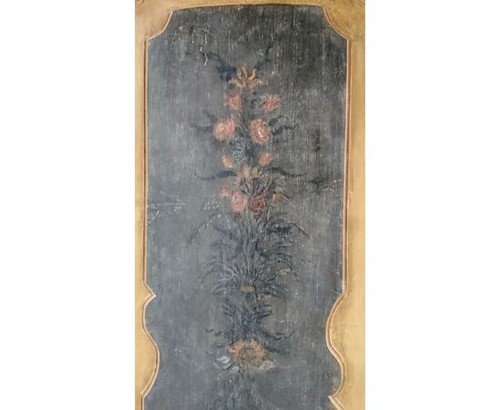 Door to a door painted with floral motifs     