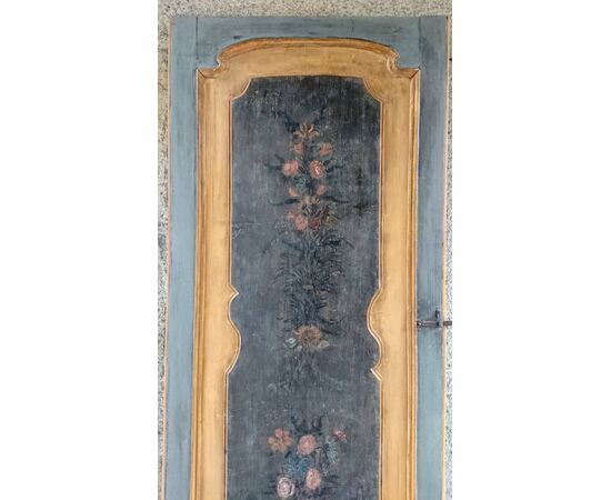Door to a door painted with floral motifs     