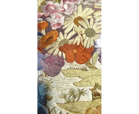 Framed panel with vase of flowers embroidered on fabric.