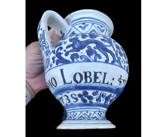 Majolica pouring vessel with turquoise decoration, calligraphic motifs, animal and plant subjects, and the date 1735. Ferniani manufacture, Faenza.