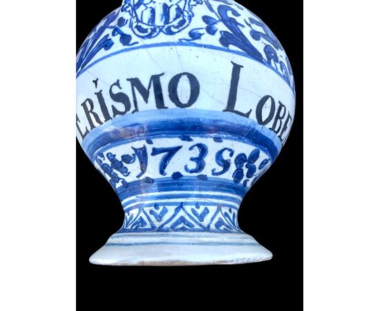 Majolica pouring vessel with turquoise decoration, calligraphic motifs, animal and plant subjects, and the date 1735. Ferniani manufacture, Faenza.