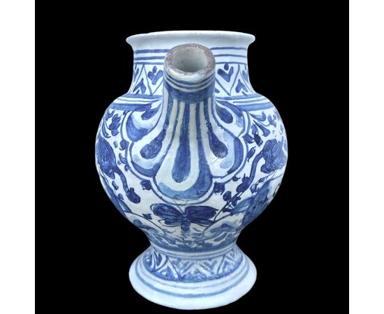 Majolica pouring vessel with turquoise decoration, calligraphic motifs, animal and plant subjects, and the date 1735. Ferniani manufacture, Faenza.