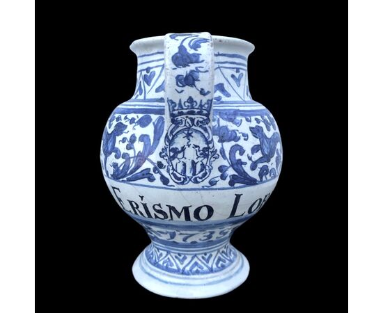 Majolica pouring vessel with turquoise decoration, calligraphic motifs, animal and plant subjects, and the date 1735. Ferniani manufacture, Faenza.