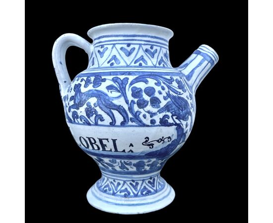 Majolica pouring vessel with turquoise decoration, calligraphic motifs, animal and plant subjects, and the date 1735. Ferniani manufacture, Faenza.