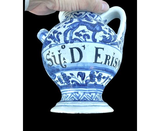 Majolica pouring vessel with turquoise decoration, calligraphic motifs, animal and plant subjects, and the date 1735. Ferniani manufacture, Faenza.