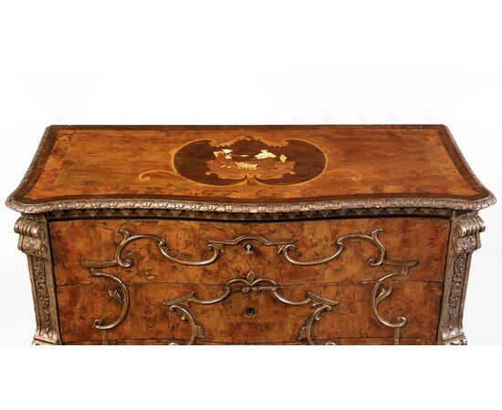 Walnut burl veneered chest of drawers, carved pilasters and gilded "a mecca" frames, rosette with inlaid scene in various woods on the top, Lombardy, 18th century