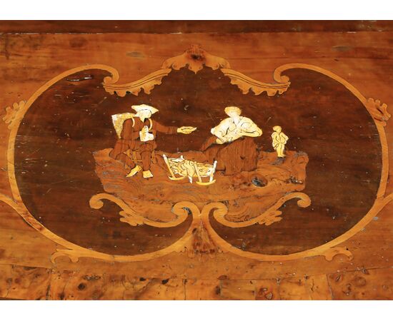 Walnut burl veneered chest of drawers, carved pilasters and gilded "a mecca" frames, rosette with inlaid scene in various woods on the top, Lombardy, 18th century