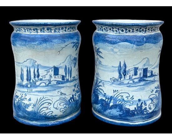 Pair of majolica albarello vases decorated with figures in a rural setting. Lantern signature. Savona.