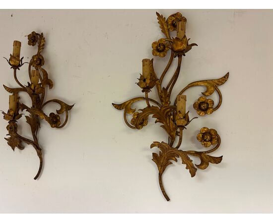 Three gilded metal sconces with floral motifs. 19th century