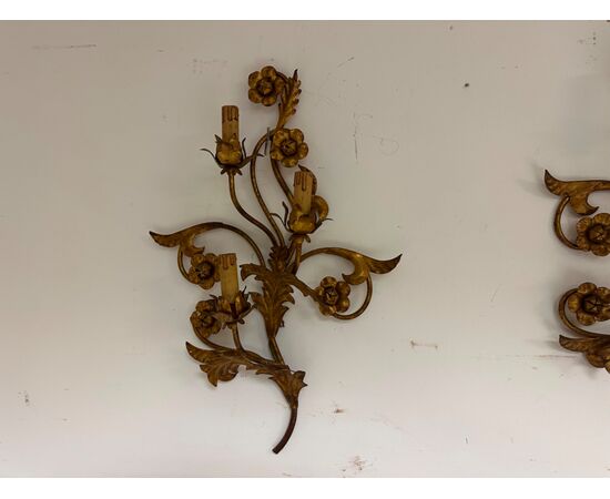 Three gilded metal sconces with floral motifs. 19th century