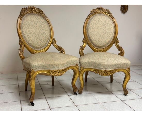 Pair of carved and gilded wooden armchairs. 19th century