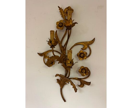 Three gilded metal sconces with floral motifs. 19th century