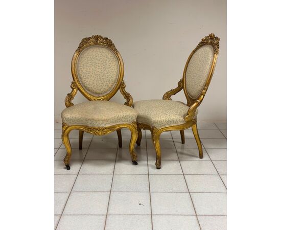 Pair of carved and gilded wooden armchairs. 19th century