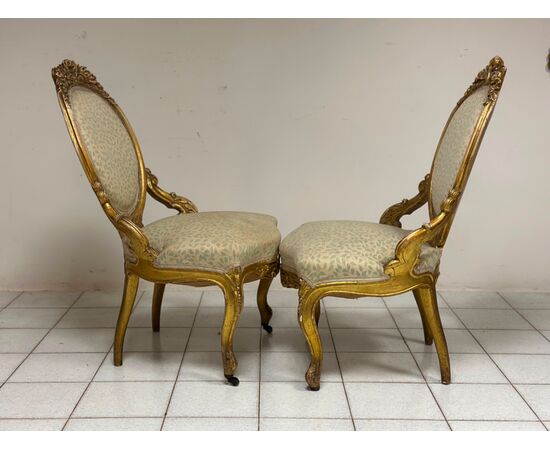 Pair of carved and gilded wooden armchairs. 19th century