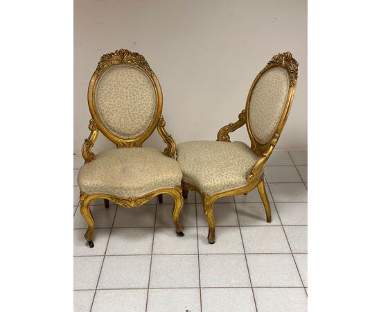 Pair of carved and gilded wooden armchairs. 19th century