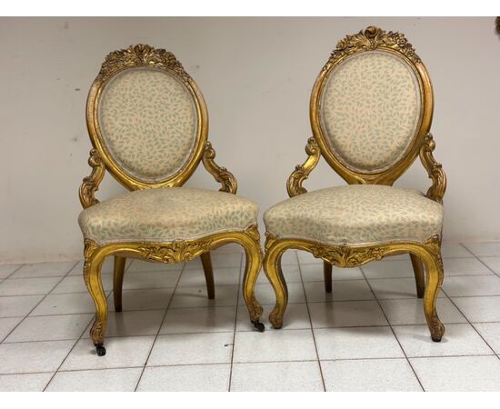 Pair of carved and gilded wooden armchairs. 19th century