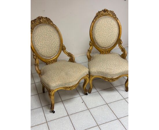 Pair of carved and gilded wooden armchairs. 19th century