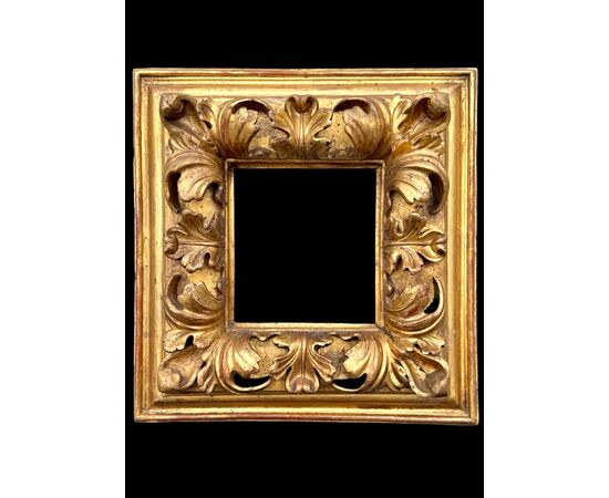 Carved and gilded wooden frame.