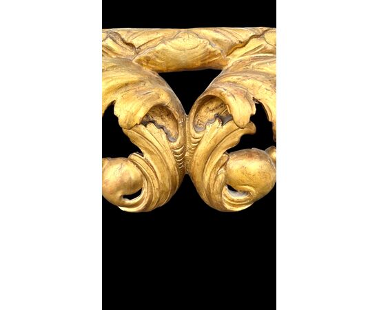 Carved and gilded wooden frame-mirror with 'cartoccio' decoration.