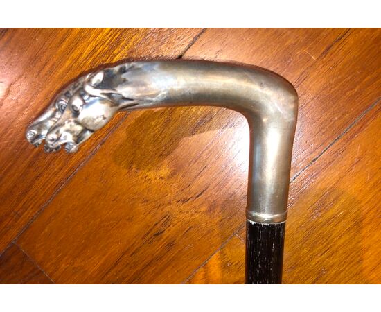 Stick with silver handle depicting two horse heads. Ebony tip     